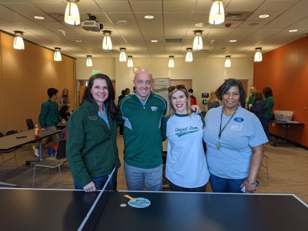 Group standing in front of Ping Pong table